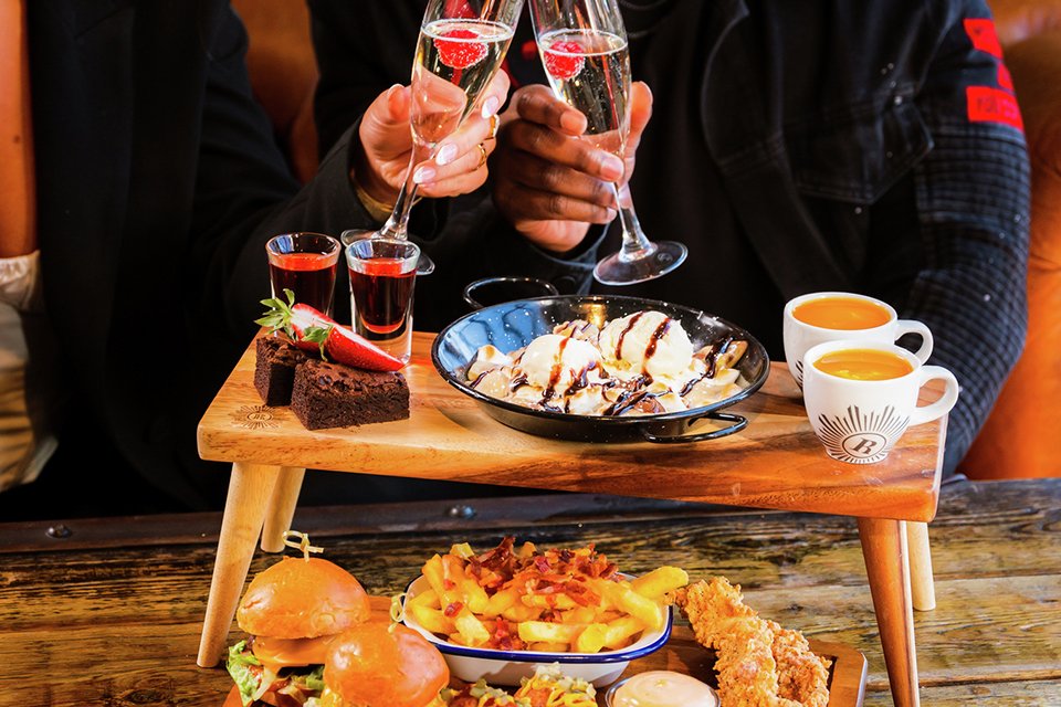 A couple enjoying Deluxe afternoon tea for two.